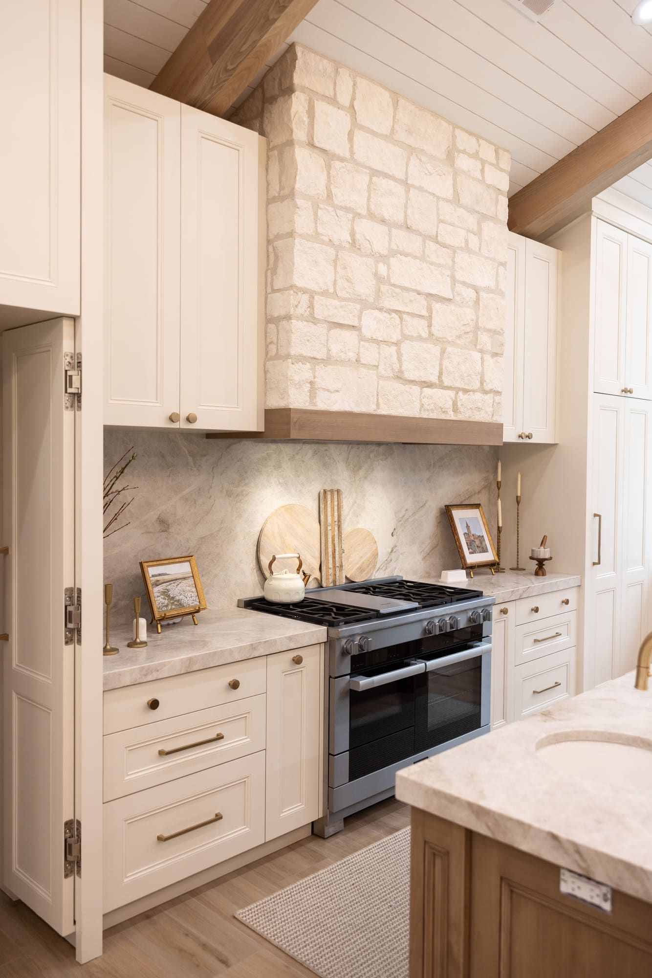 White custom kitchen cabinetry with dark alder wood accents